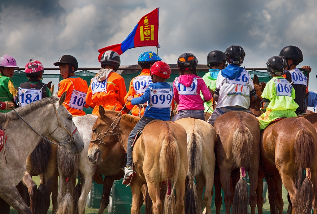 Mongolian children on their horses at the start line of a Naadam Festival horse race. Taken during a Mongolia small group experiences