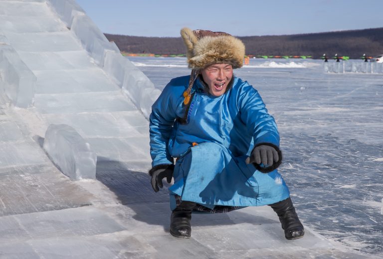 mongolian people dressed in traditional clothing on a frozen lak