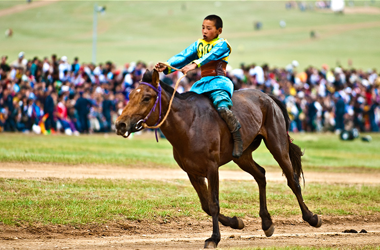 A young jockey competing at the Mongolian horse racing during the national level Naadam Festival in Mongolia