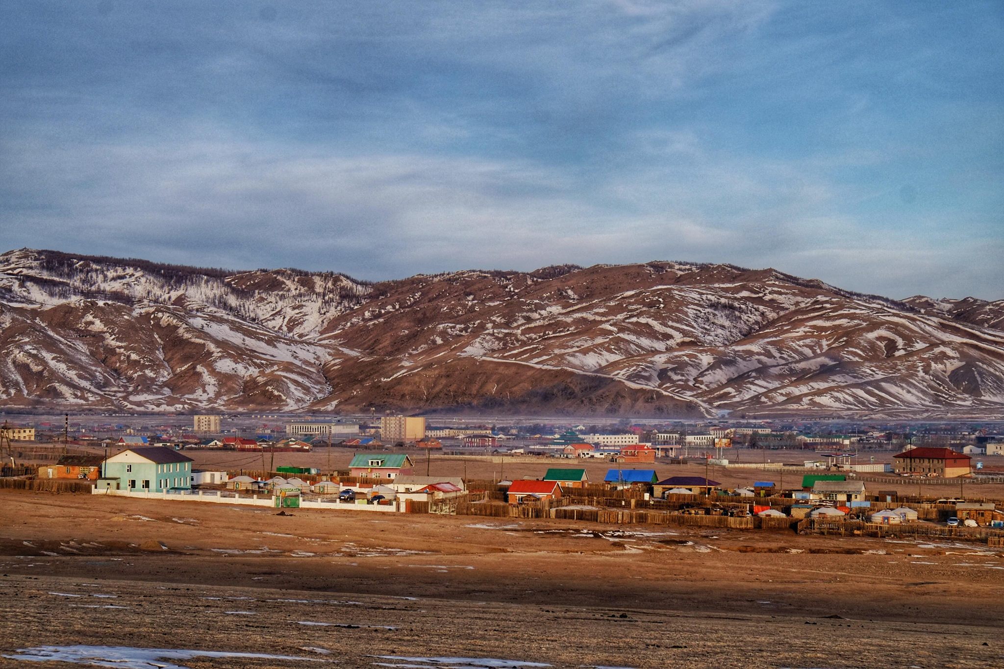 The town of Kharkhorin in central Mongolia with snow on the hilltops