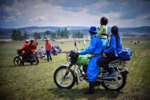 Mongolian family on motorbike during Naadam Festival
